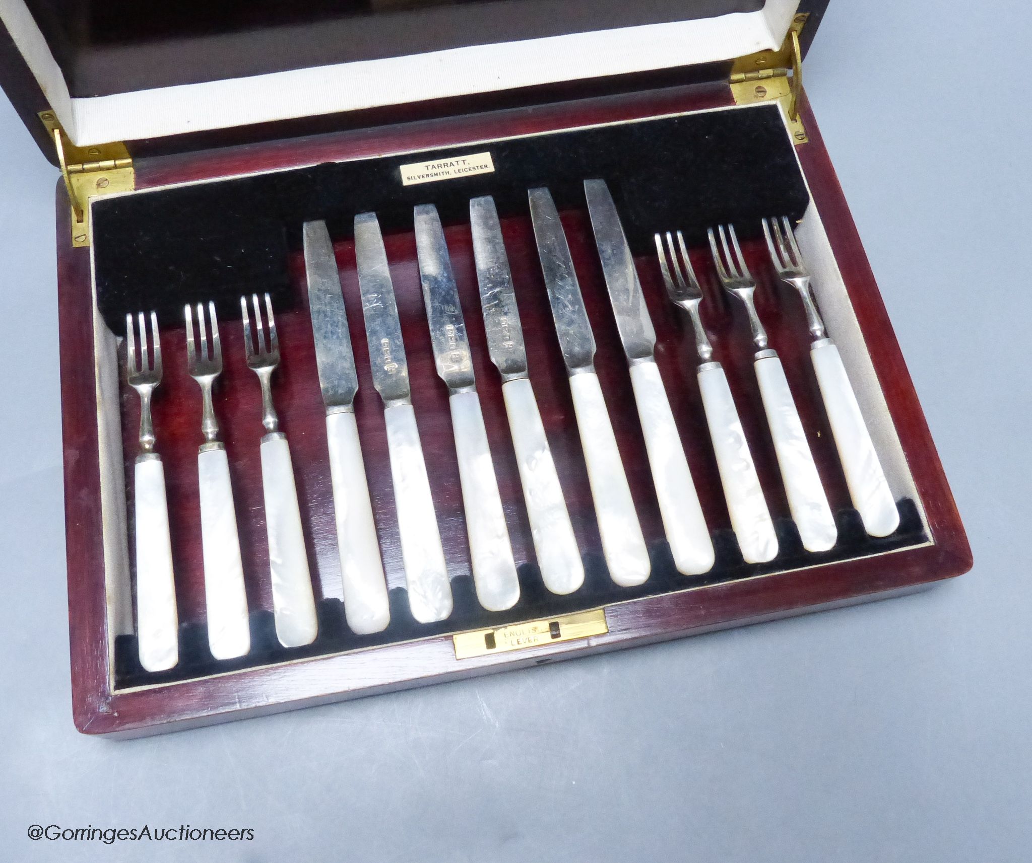 A George V cased set of six pairs of mother of pearl handled silver dessert eaters, Sheffield, 1933.